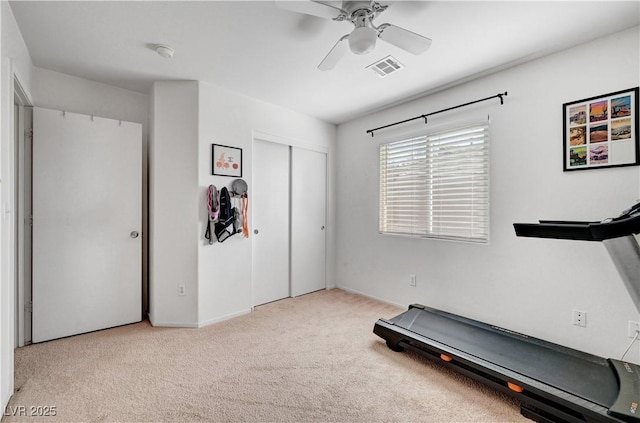 workout room with light colored carpet and ceiling fan