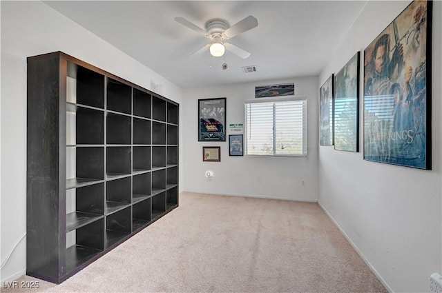 unfurnished room featuring carpet and ceiling fan