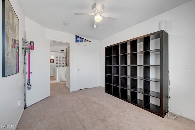 unfurnished bedroom with ceiling fan and carpet flooring