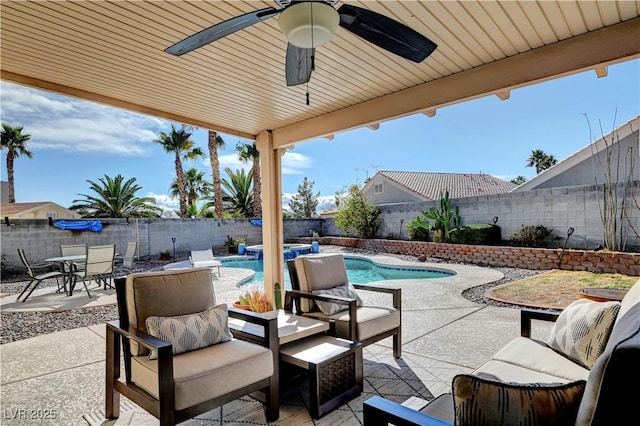 view of patio with an outdoor living space, ceiling fan, and a fenced in pool