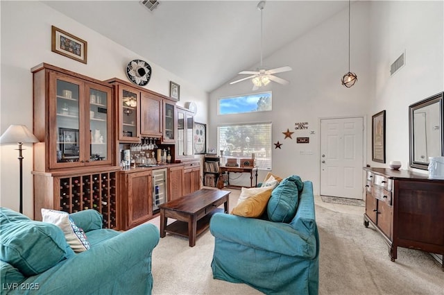 sitting room featuring ceiling fan, vaulted ceiling, light colored carpet, and wine cooler