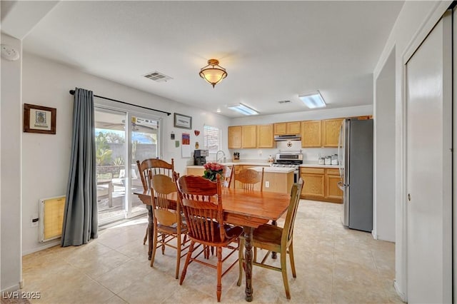 dining room with light tile patterned floors and sink