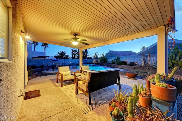 view of patio with ceiling fan and a fenced in pool