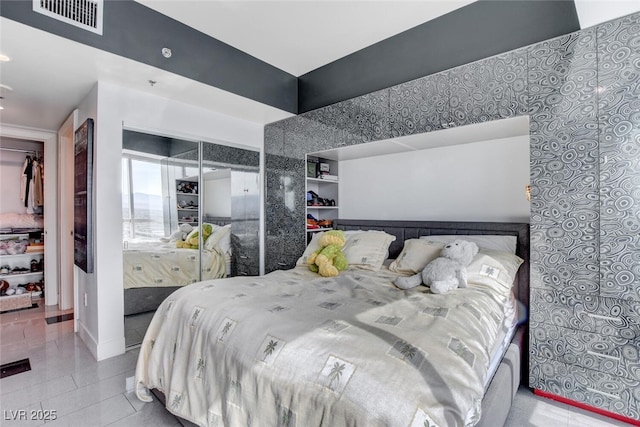 tiled bedroom with a closet