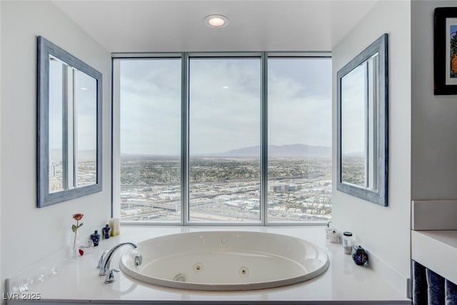 bathroom featuring a mountain view and tiled tub