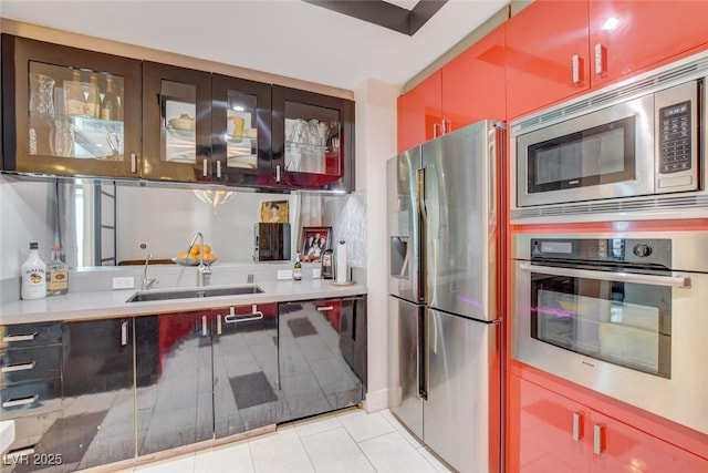 kitchen with sink, stainless steel appliances, and light tile patterned floors