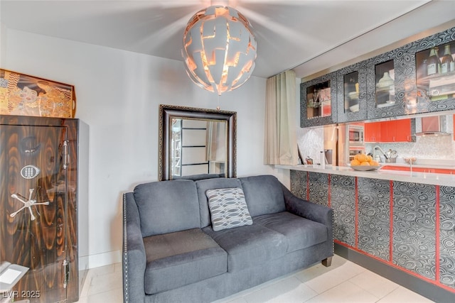 tiled living room featuring a chandelier and sink