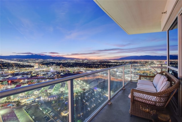 balcony at dusk featuring a mountain view