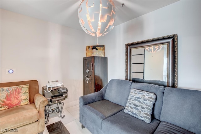 living room with light tile patterned floors and a chandelier