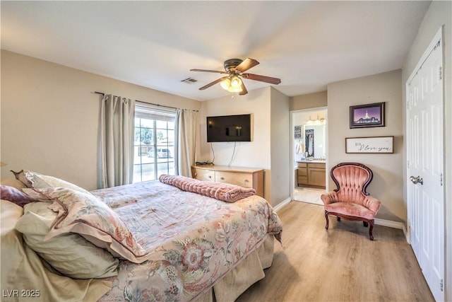 bedroom with a closet, connected bathroom, ceiling fan, and light hardwood / wood-style flooring