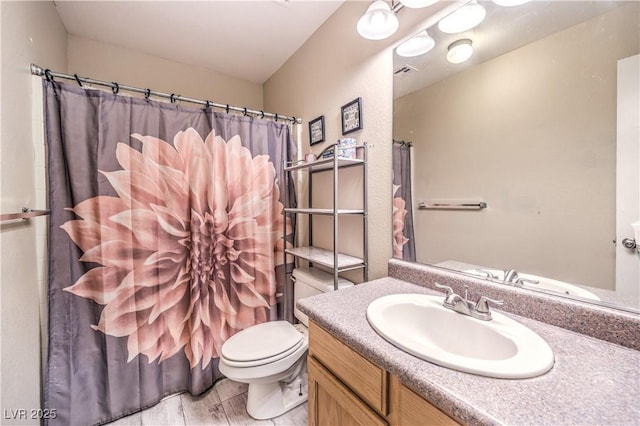 bathroom featuring vanity and toilet