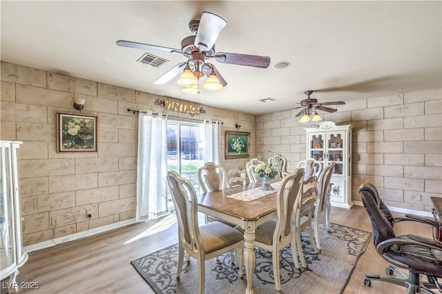 dining area featuring hardwood / wood-style floors and ceiling fan