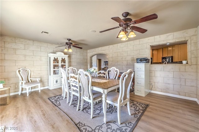 dining space featuring ceiling fan and light hardwood / wood-style flooring