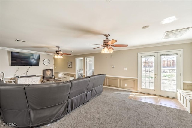 living room featuring light carpet, french doors, ceiling fan, and ornamental molding