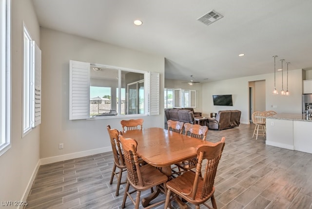 dining area with ceiling fan and light hardwood / wood-style floors