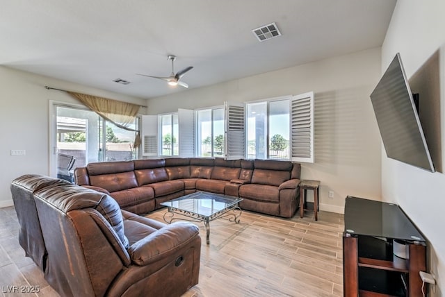 living room featuring ceiling fan and light wood-type flooring