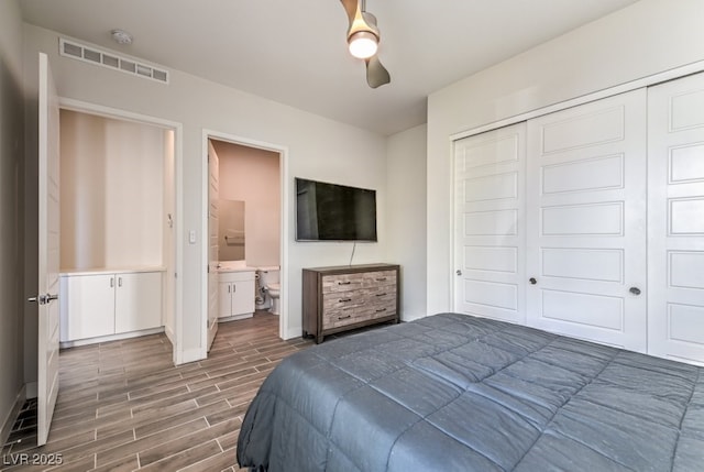 bedroom with ceiling fan, a closet, and ensuite bath