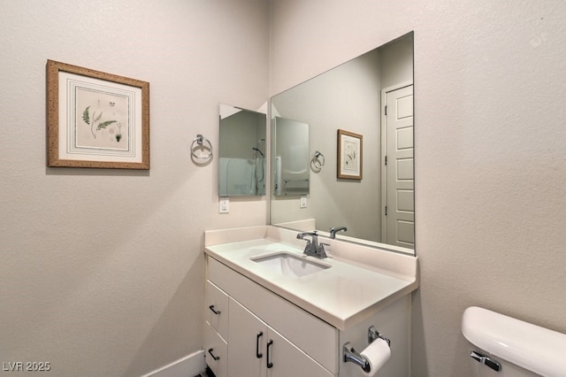 bathroom featuring toilet and vanity