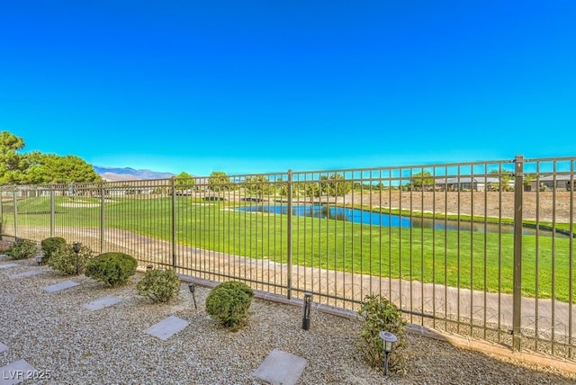 surrounding community with a yard and a water and mountain view