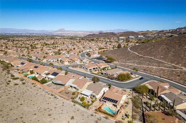 birds eye view of property with a mountain view