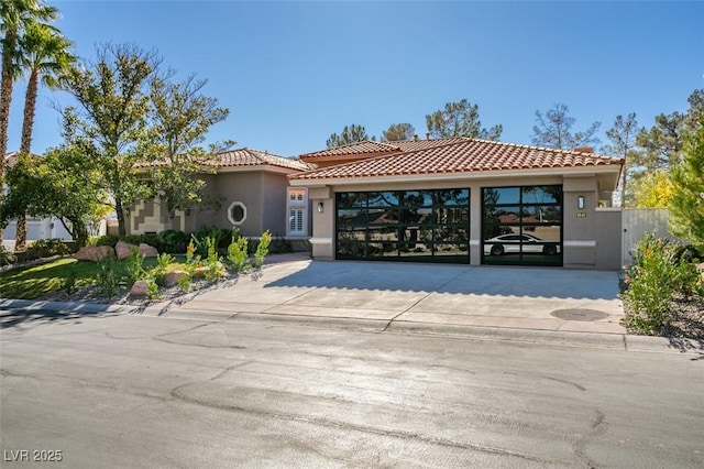 mediterranean / spanish home featuring a garage