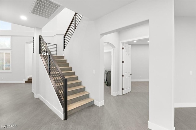 staircase featuring lofted ceiling and hardwood / wood-style floors