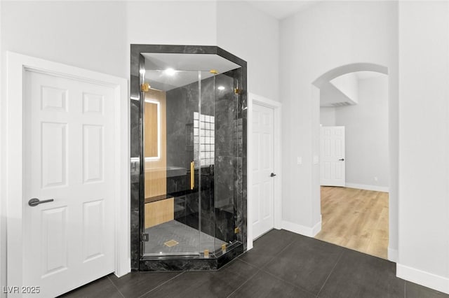 bathroom with tile patterned floors and walk in shower