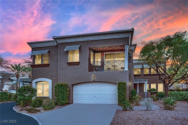 view of front of house featuring a garage and a balcony