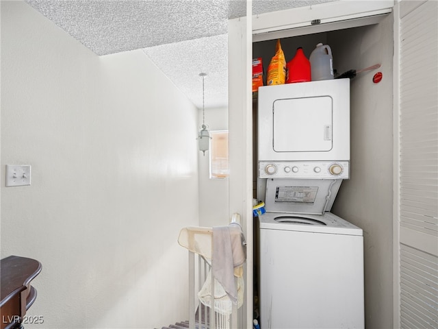 laundry area featuring a textured ceiling and stacked washing maching and dryer