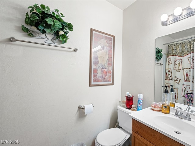 bathroom with toilet and vanity