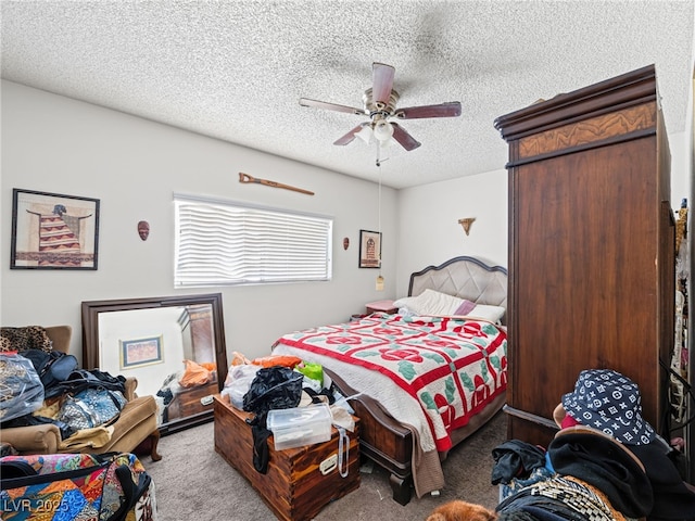 carpeted bedroom featuring ceiling fan and a textured ceiling