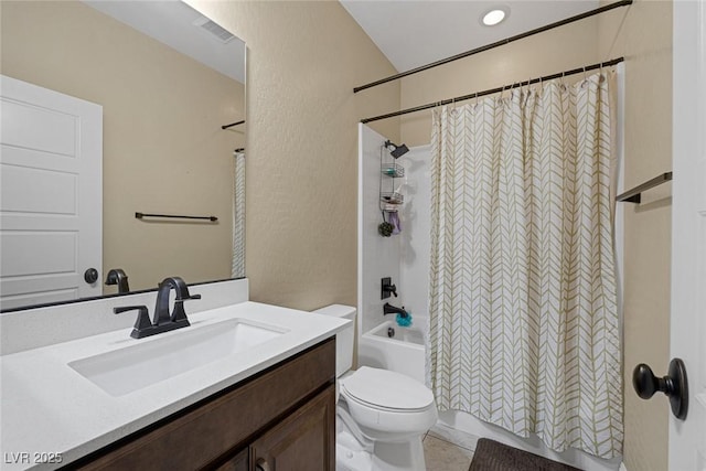 full bathroom featuring toilet, a textured wall, shower / tub combo with curtain, and vanity