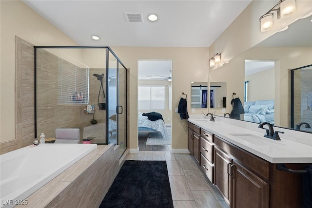 ensuite bathroom with visible vents, connected bathroom, a sink, and double vanity