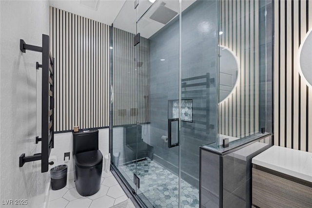 full bath with vanity, a stall shower, tile patterned flooring, and toilet