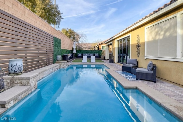 view of pool featuring a fenced backyard, outdoor lounge area, a fenced in pool, and a patio