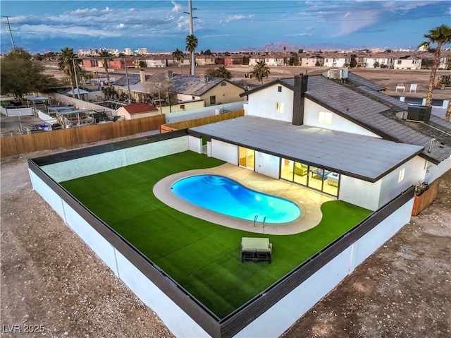 view of pool featuring a yard, cooling unit, and a patio area