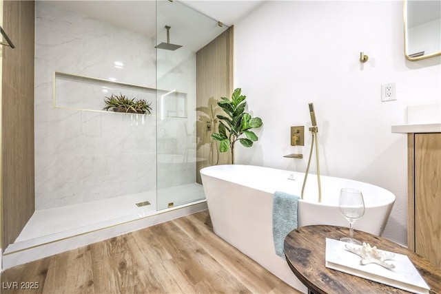 bathroom featuring a wall mounted AC, shower with separate bathtub, and hardwood / wood-style floors