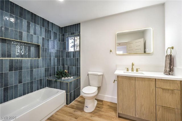 full bathroom featuring hardwood / wood-style flooring, shower / washtub combination, toilet, tile walls, and vanity