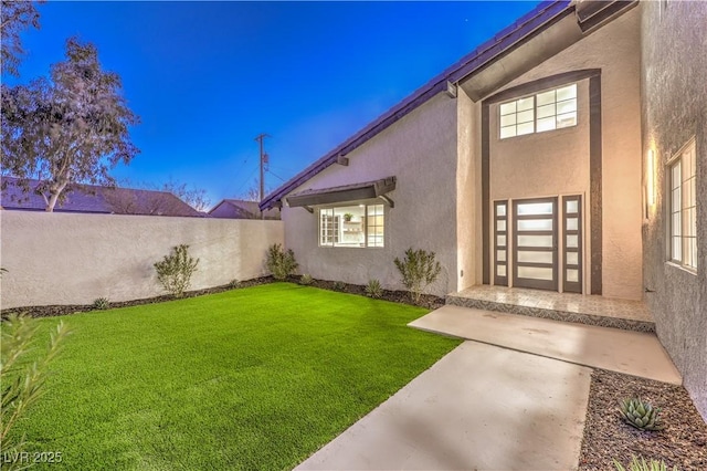 yard at dusk with a patio