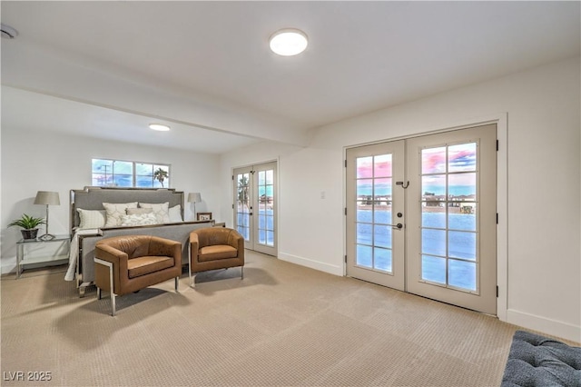 carpeted bedroom featuring access to exterior, french doors, and multiple windows