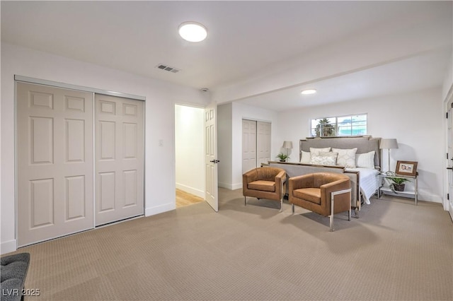 carpeted bedroom featuring two closets