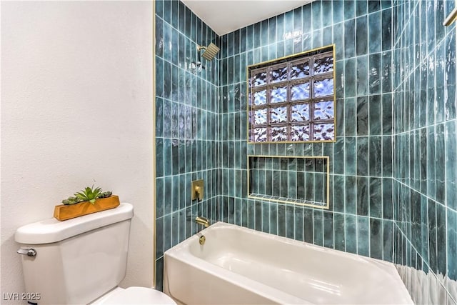 bathroom featuring toilet and tiled shower / bath combo