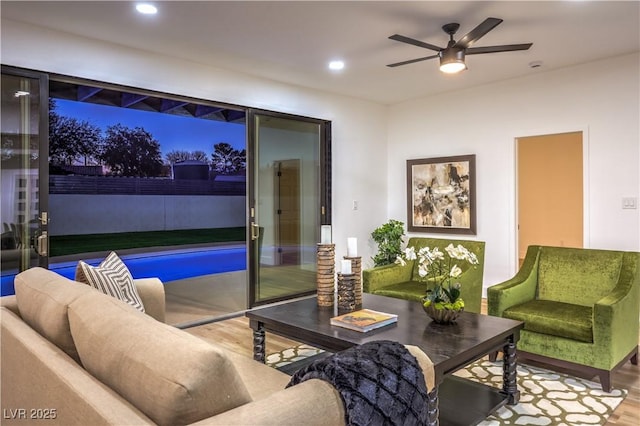 living room with hardwood / wood-style flooring and ceiling fan