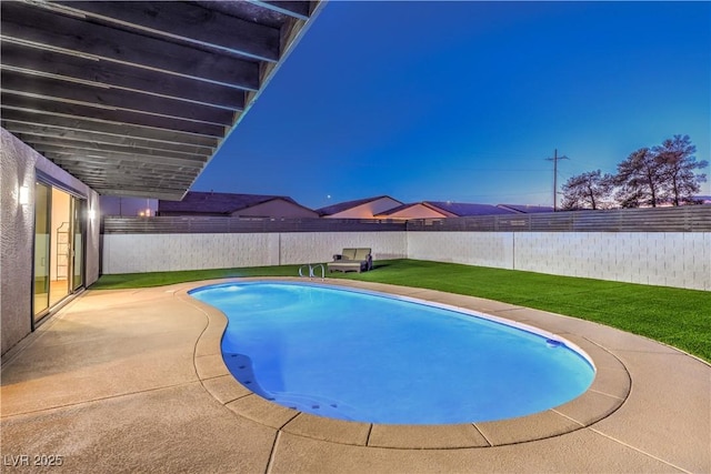 pool at dusk with a yard