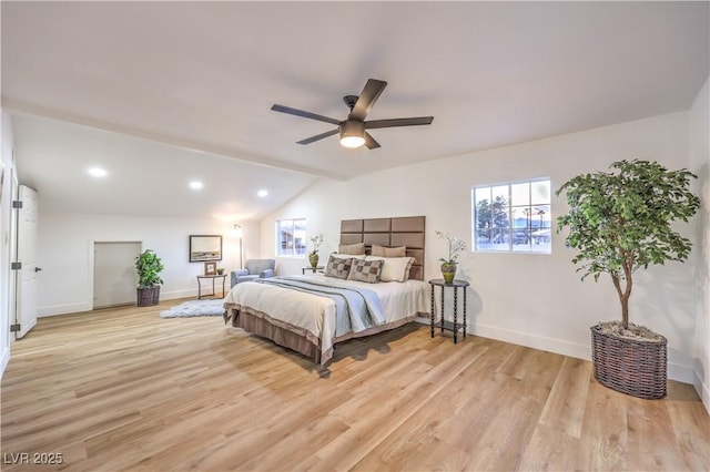 bedroom featuring light wood-type flooring, vaulted ceiling, and ceiling fan