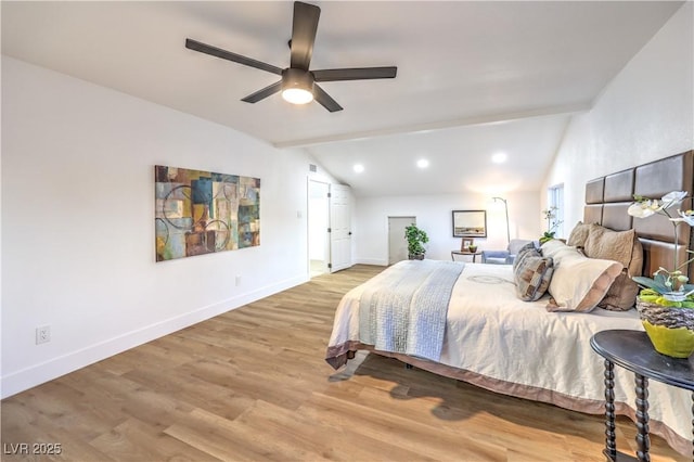 bedroom with ceiling fan, light hardwood / wood-style flooring, and vaulted ceiling with beams