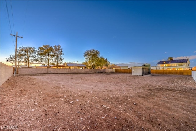 yard at dusk featuring a storage shed