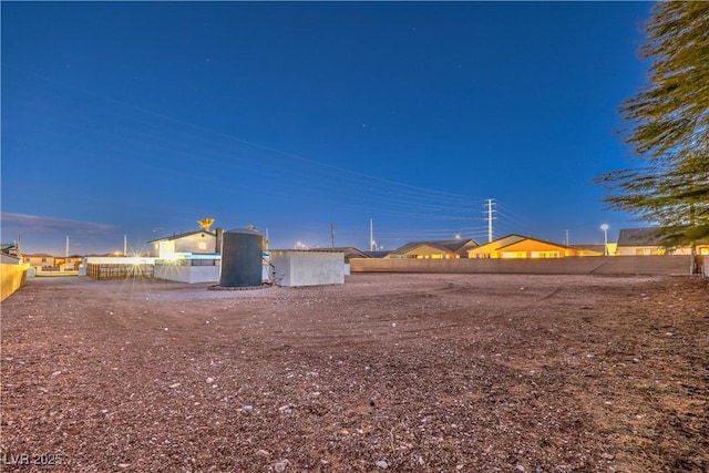 view of yard at dusk