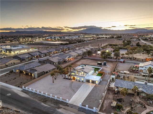 aerial view at dusk featuring a mountain view