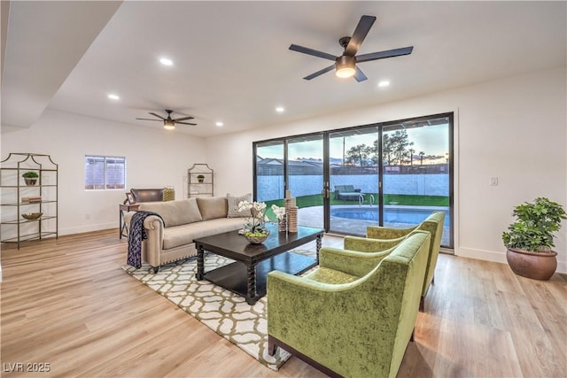 living room featuring ceiling fan and light hardwood / wood-style flooring